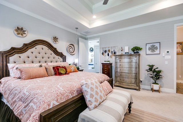 carpeted bedroom featuring ceiling fan, ornamental molding, and a tray ceiling