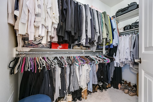 walk in closet with carpet