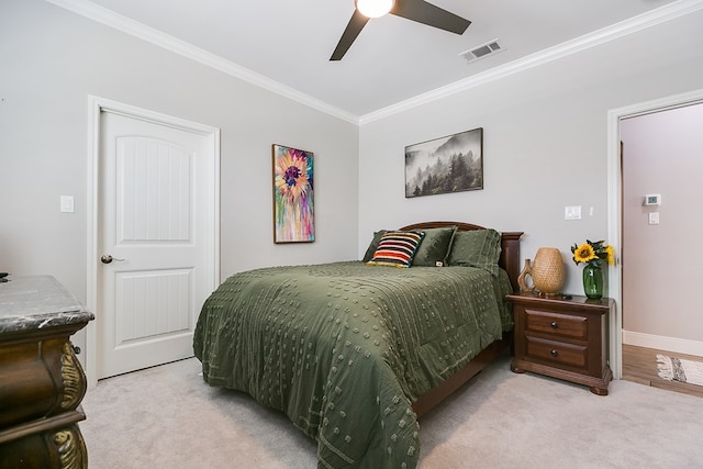 carpeted bedroom featuring ornamental molding and ceiling fan