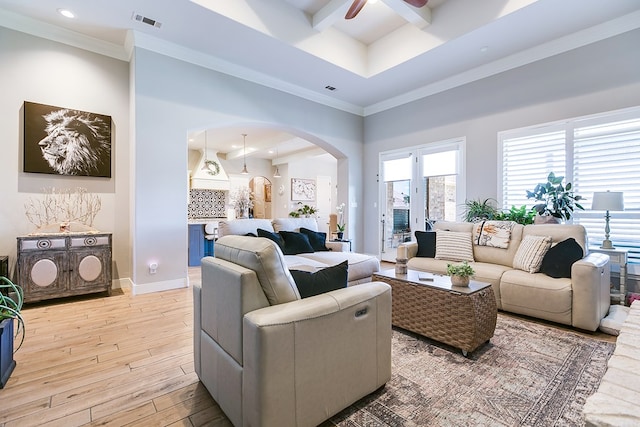 living room with crown molding, ceiling fan, beam ceiling, a high ceiling, and light hardwood / wood-style floors