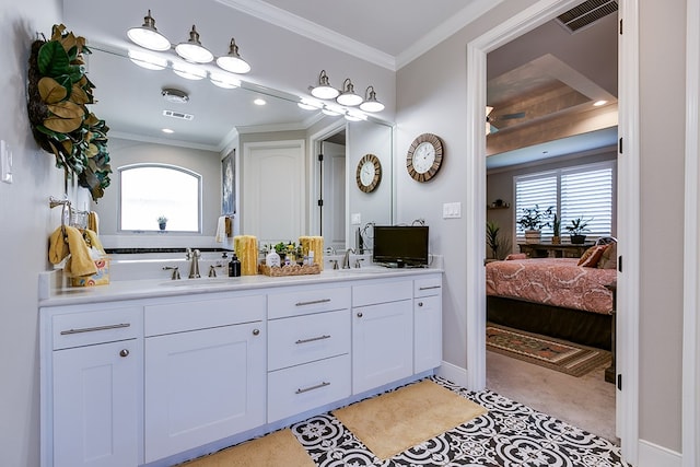 bathroom with ornamental molding and vanity