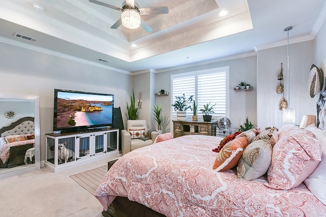 carpeted bedroom featuring crown molding, ceiling fan, and a tray ceiling