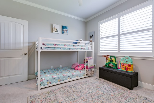 carpeted bedroom with ornamental molding and ceiling fan