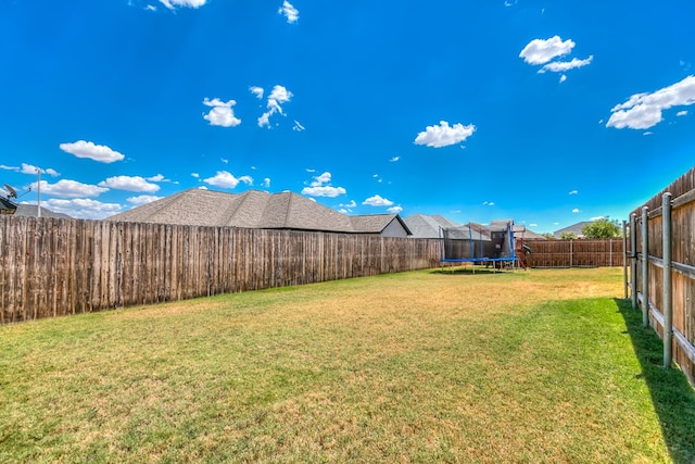 view of yard with a trampoline