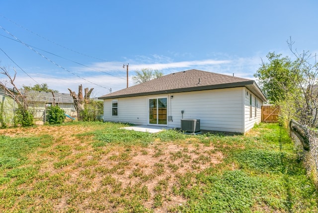 rear view of property featuring a patio, a fenced backyard, and central AC