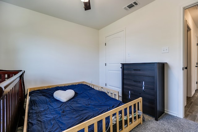 bedroom with a ceiling fan, baseboards, visible vents, and carpet floors