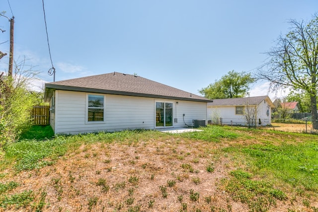 rear view of property with central AC and fence