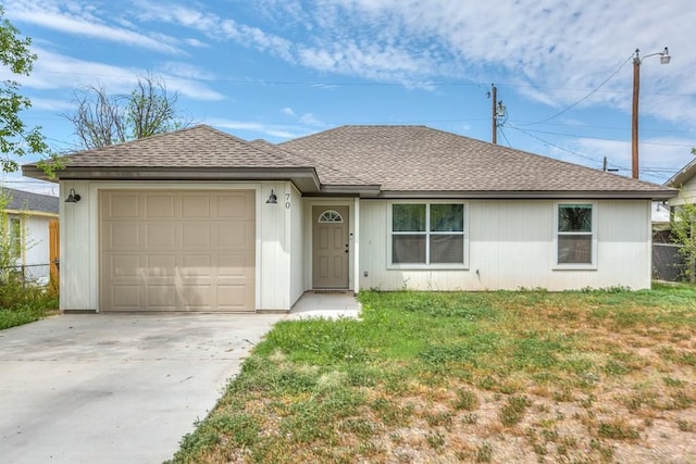 ranch-style home with a front lawn, fence, concrete driveway, roof with shingles, and a garage