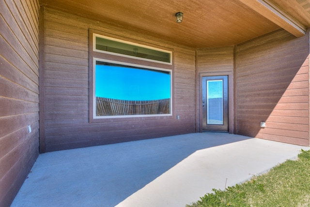 view of exterior entry featuring a patio