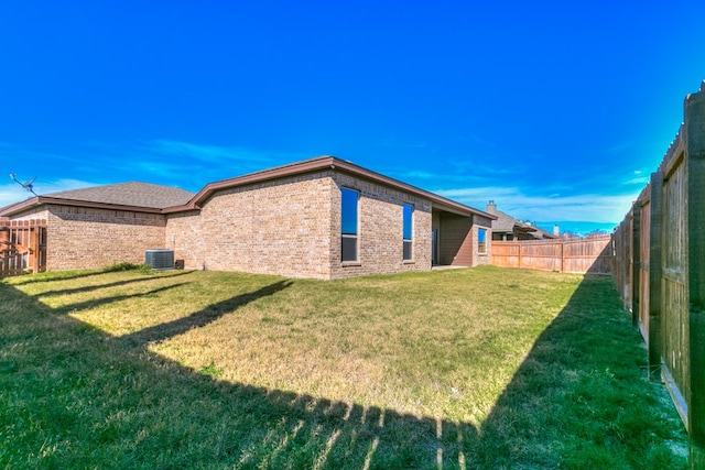 exterior space with central air condition unit and a fenced backyard