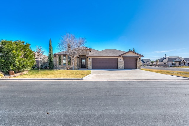 view of front of home with a front lawn, an attached garage, stone siding, and driveway