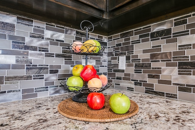 room details featuring stone counters and backsplash