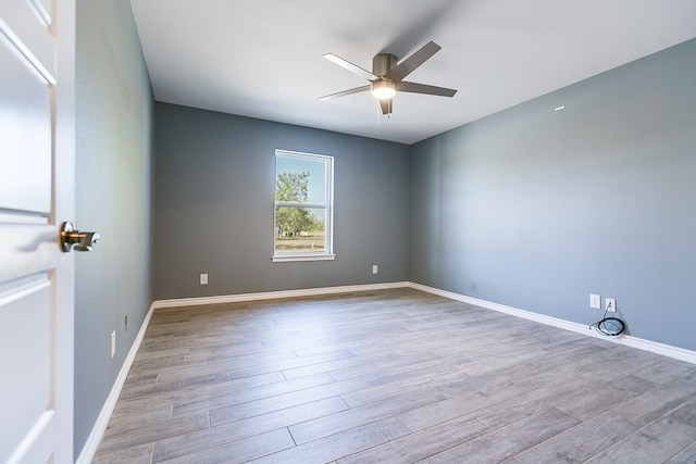 spare room featuring light hardwood / wood-style flooring and ceiling fan