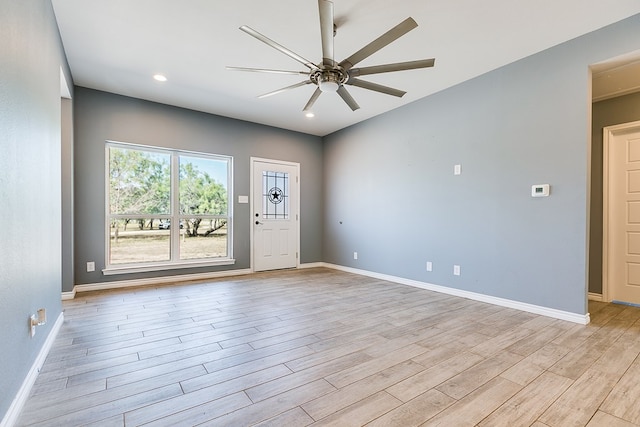 spare room with ceiling fan and light hardwood / wood-style flooring