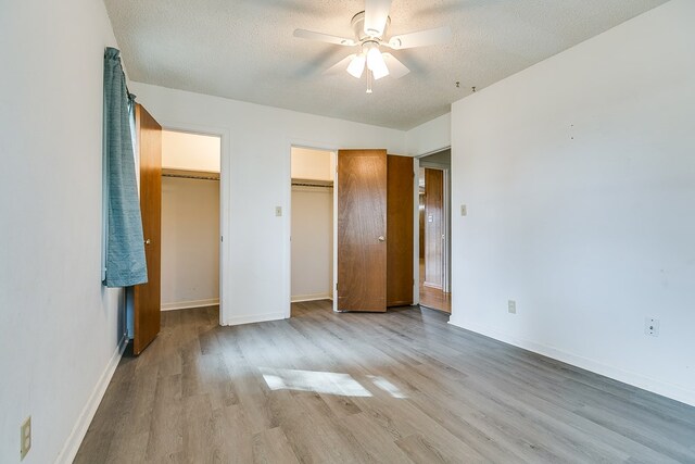 unfurnished bedroom with a textured ceiling, ceiling fan, and light hardwood / wood-style flooring