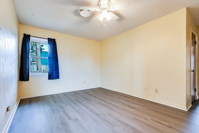 spare room with hardwood / wood-style floors, a textured ceiling, and ceiling fan