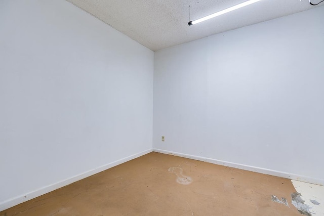 unfurnished room featuring concrete floors and a textured ceiling