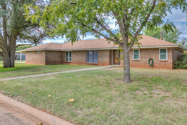 ranch-style home with a front lawn