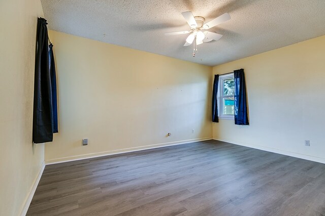 spare room featuring ceiling fan, hardwood / wood-style floors, and a textured ceiling