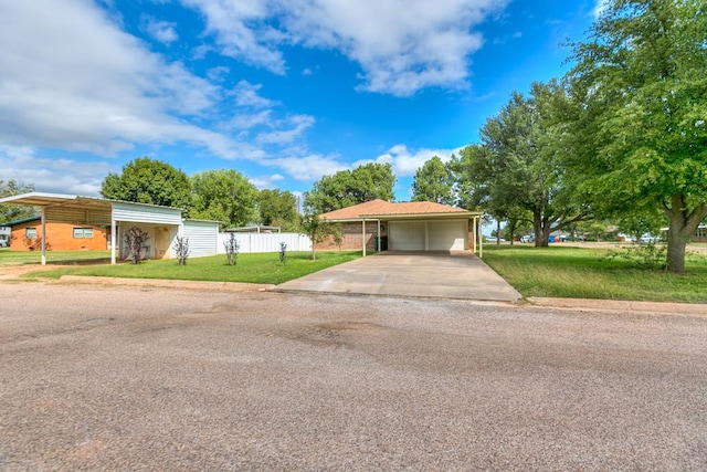 view of front of property with a garage, a front yard, and a carport