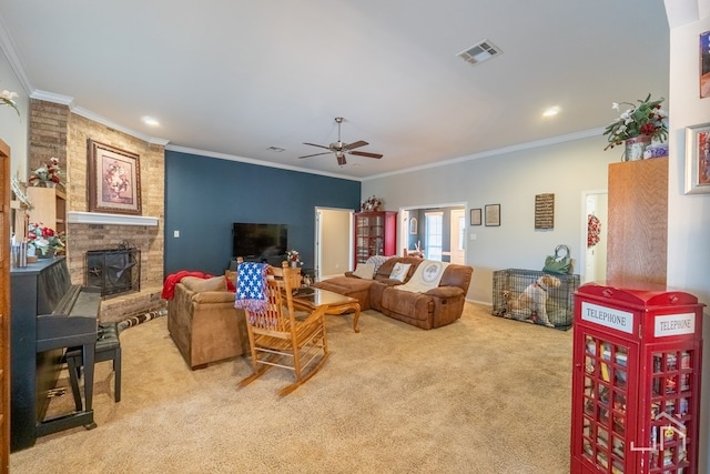 living area with carpet flooring, ornamental molding, visible vents, a ceiling fan, and a fireplace