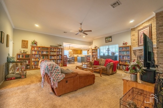 living room featuring ornamental molding, visible vents, light carpet, and ceiling fan