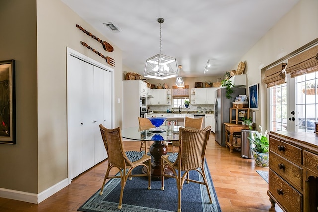 4929 Bermuda Dr, San Angelo, TX 76904 - dining area featuring healthy amount of natural light, wood finished floors, and baseboards