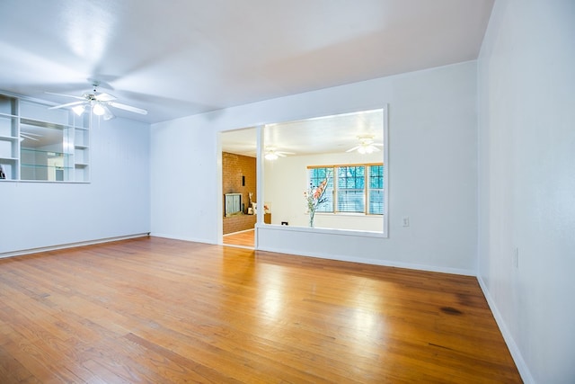 2609 W Harris Ave, San Angelo, TX 76901 - unfurnished living room featuring a ceiling fan and wood finished floors