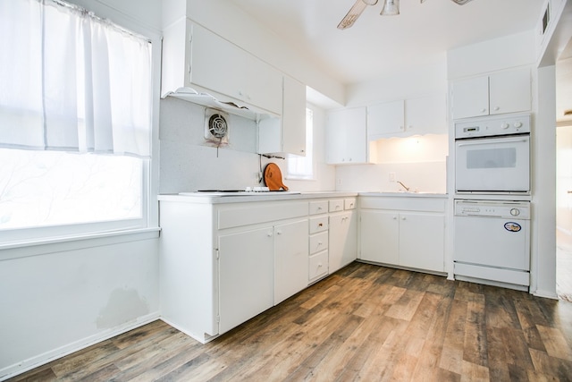 2609 W Harris Ave, San Angelo, TX 76901 - kitchen with white appliances, wood finished floors, white cabinets, and light countertops