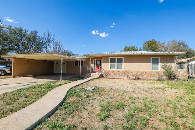 ranch-style house with a carport and a front lawn