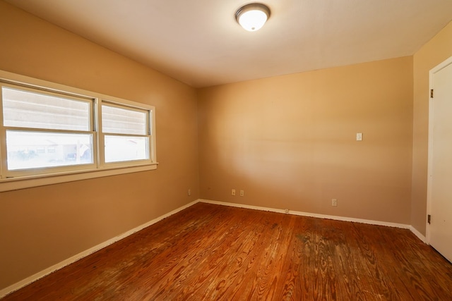 unfurnished room with hardwood / wood-style floors