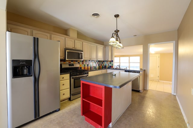 kitchen with a kitchen island, appliances with stainless steel finishes, pendant lighting, tasteful backsplash, and sink