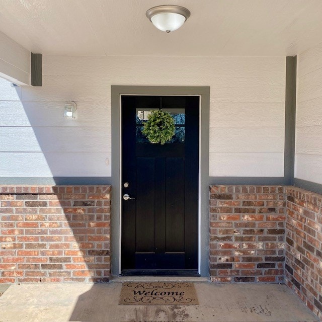 entrance to property with brick siding