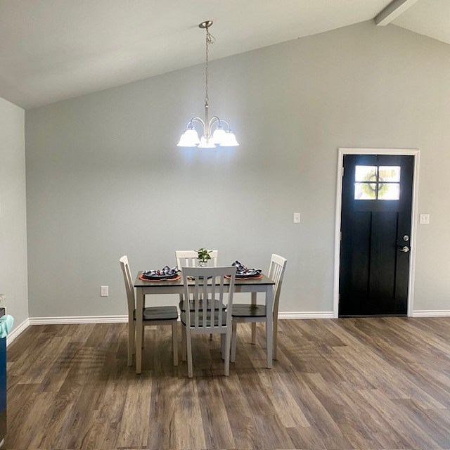 dining room with vaulted ceiling with beams, baseboards, dark wood finished floors, and a notable chandelier