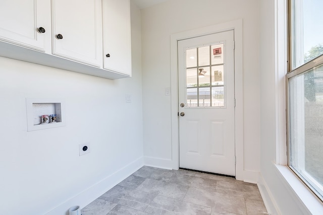 laundry area featuring electric dryer hookup, hookup for a washing machine, and cabinets