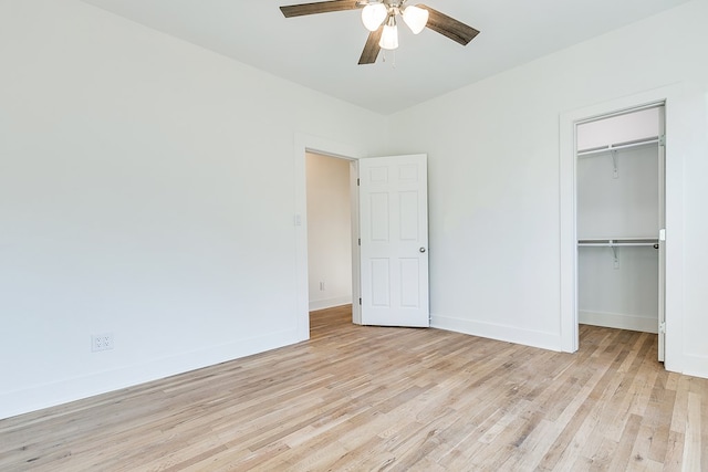 unfurnished bedroom featuring ceiling fan, light hardwood / wood-style floors, and a closet