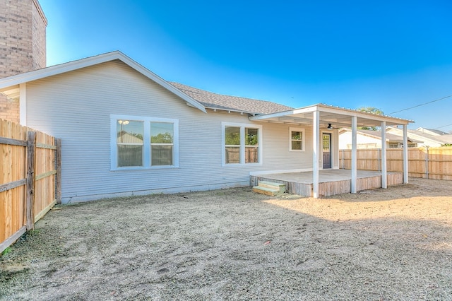 rear view of house featuring ceiling fan