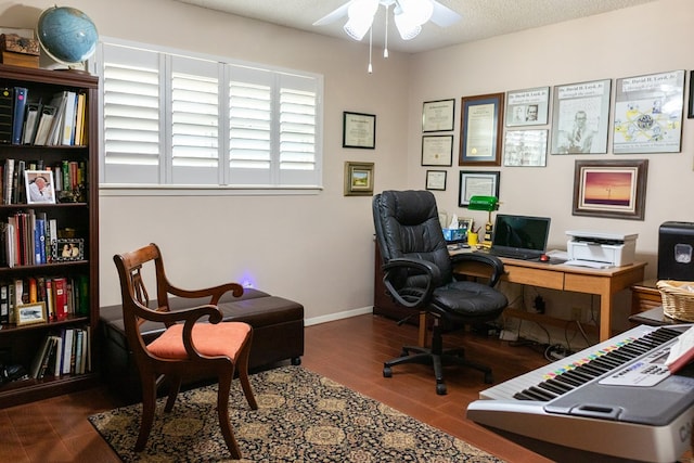 office space featuring ceiling fan, a textured ceiling, baseboards, and wood finished floors