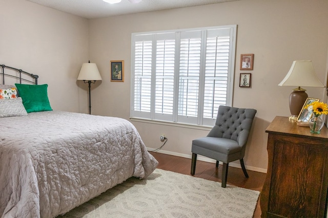 bedroom featuring baseboards and wood finished floors