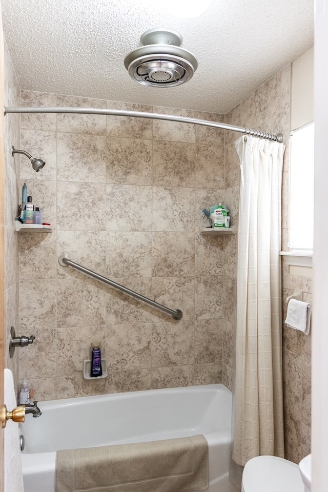 full bathroom with toilet, a textured ceiling, and shower / tub combo with curtain