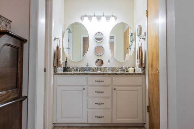 bathroom featuring double vanity and a sink