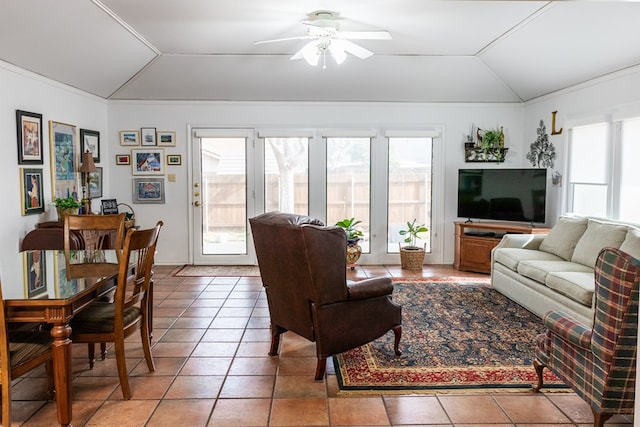 living room with lofted ceiling, light tile patterned flooring, and a healthy amount of sunlight