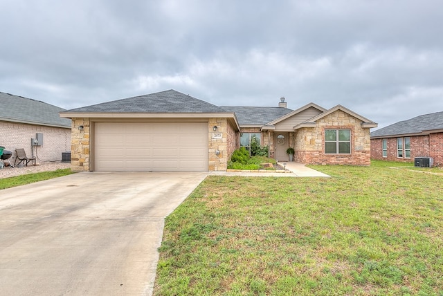 2873 Joshua St, San Angelo, TX 76905 - ranch-style home with central AC, concrete driveway, a garage, stone siding, and a front yard