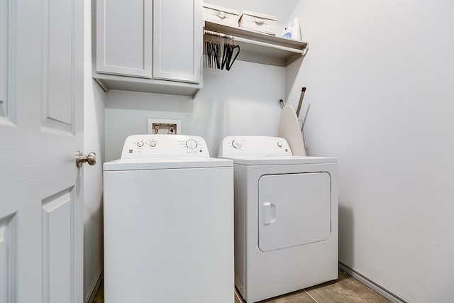 2873 Joshua St, San Angelo, TX 76905 - washroom with washing machine and clothes dryer, cabinet space, and baseboards