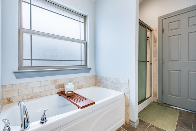 2873 Joshua St, San Angelo, TX 76905 - bathroom with a bath, a shower with shower door, and tile patterned flooring