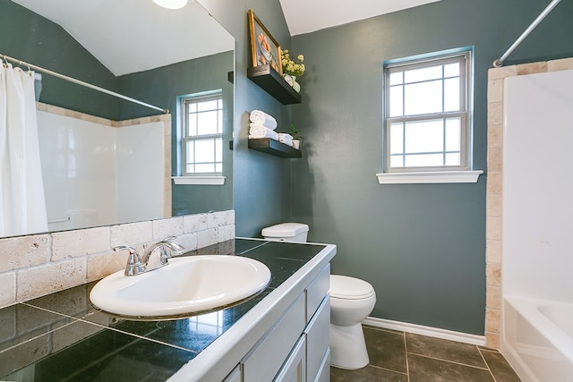 2873 Joshua St, San Angelo, TX 76905 - bathroom featuring toilet, vanity, shower / tub combo, lofted ceiling, and tile patterned flooring
