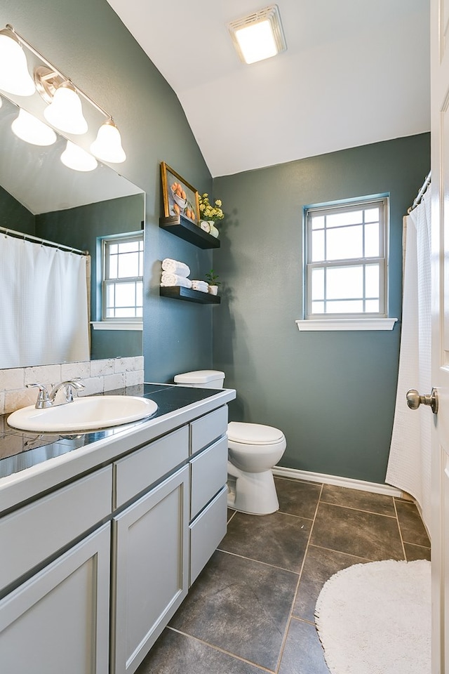 2873 Joshua St, San Angelo, TX 76905 - full bath featuring lofted ceiling, vanity, and toilet