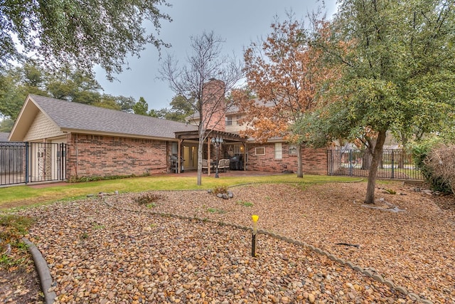 2805 Alta Vista Ln, San Angelo, TX 76904 - back of property featuring brick siding, a chimney, a pergola, and roof with shingles