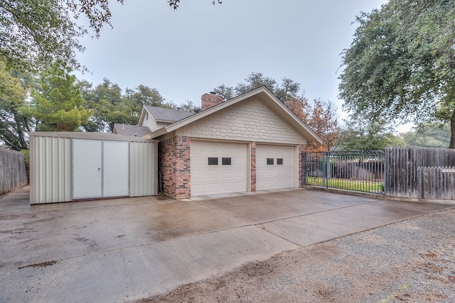 2805 Alta Vista Ln, San Angelo, TX 76904 - garage with concrete driveway and a storage unit