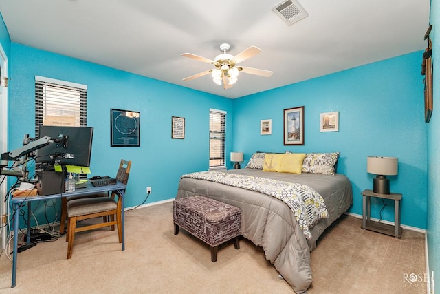 carpeted bedroom with ceiling fan, baseboards, and visible vents